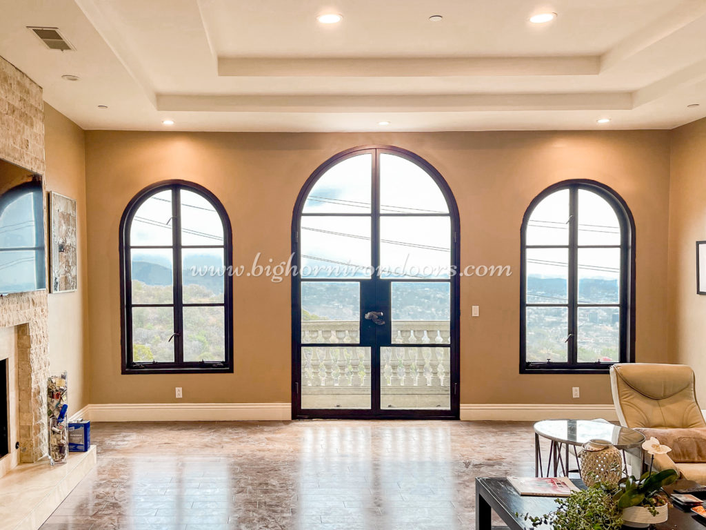 A close-up of a beautiful house with elegant doors and windows installed on its entryways.