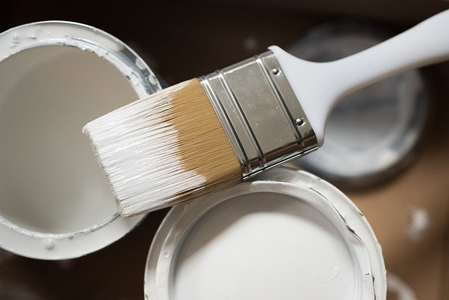 Paintbrush and cans of paint