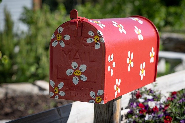 Red mailbox decorated with white flowers
