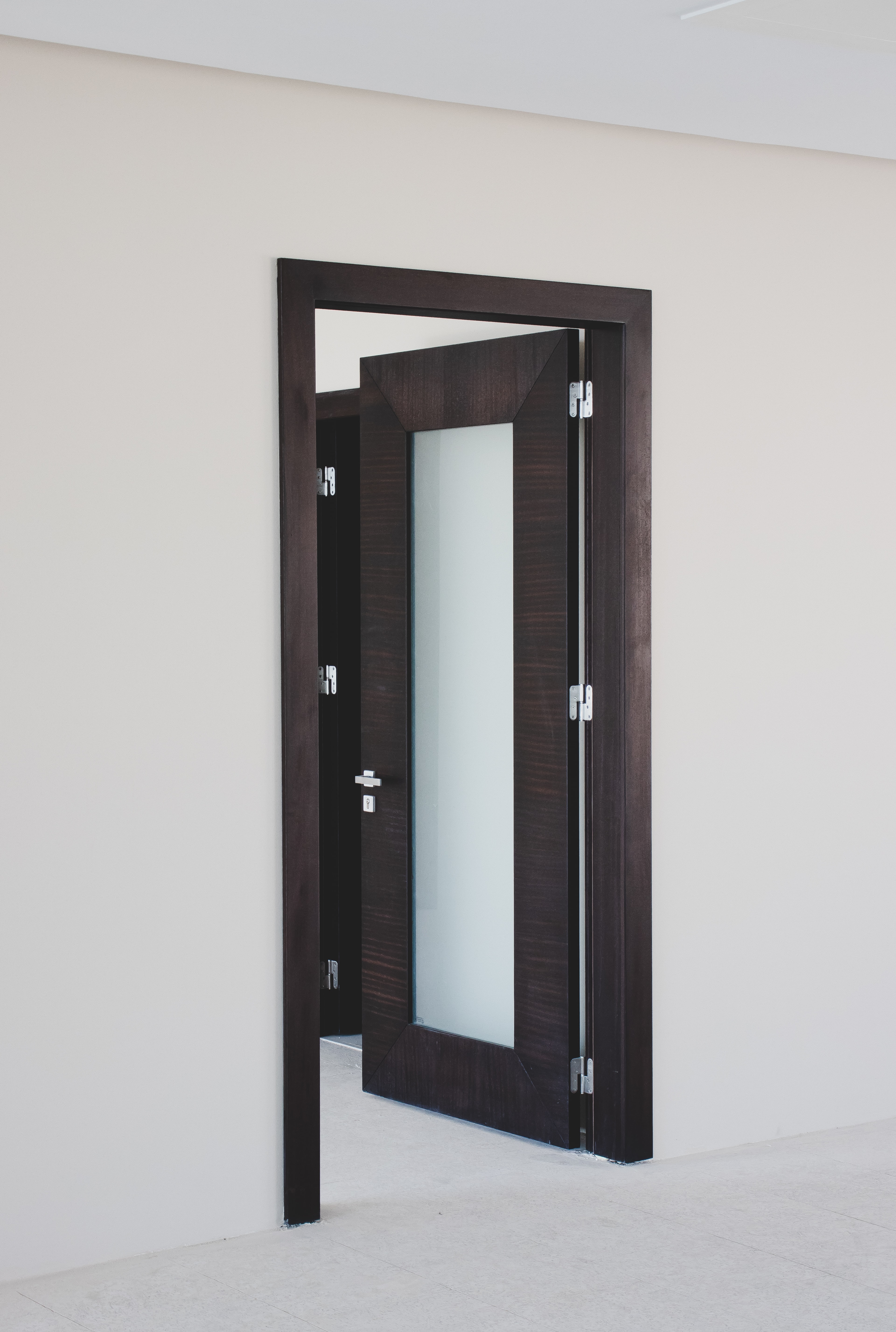 A close-up of an elegant Inswing door swinging inside the room.